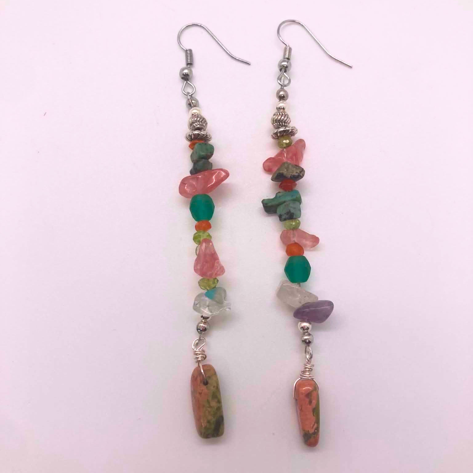 Long linear mixed crystal chip earrings with wire-wrapped unakite pendant on white background
