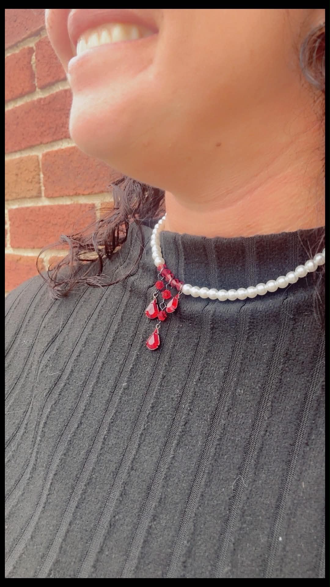 Vampire Pearls glass pearl and dark red crystal statement necklace worn at the neckline