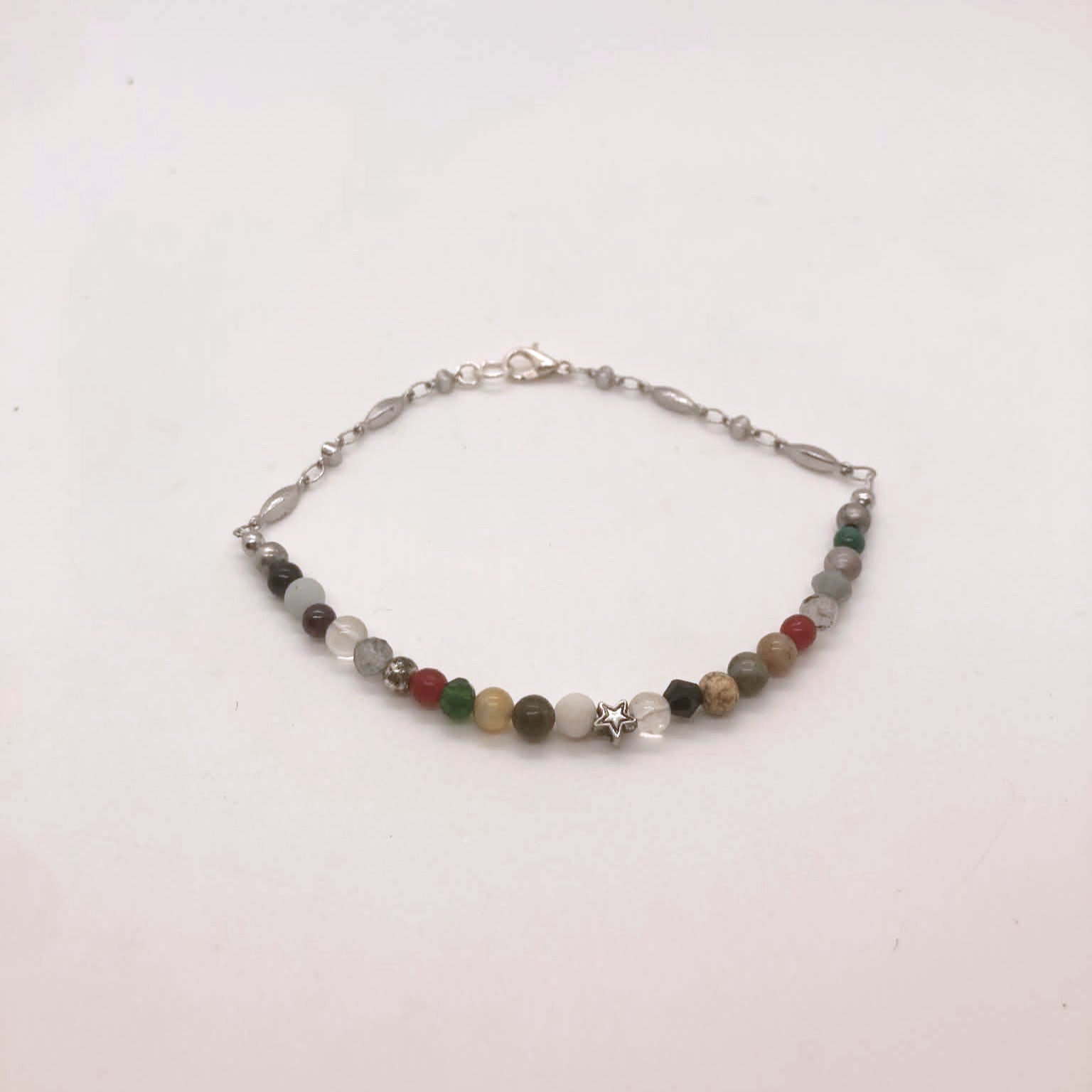Dainty figaro chain bracelet with garnet, jade, coral, jasper and mookaite beads and a silver star charm centerpiece