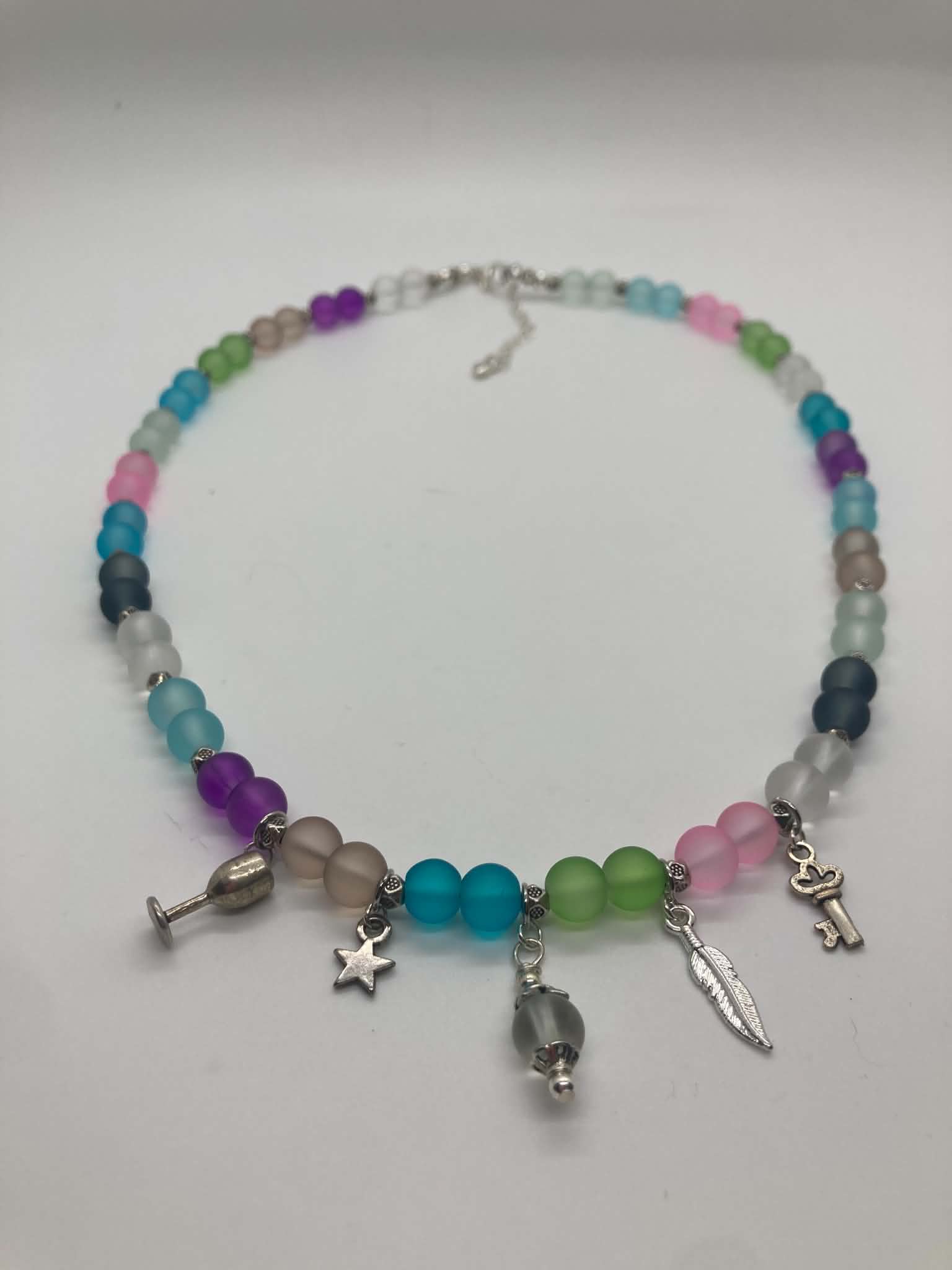 Tripping Billies Necklace - multicolor frosted glass bead necklace with silver charms, front view