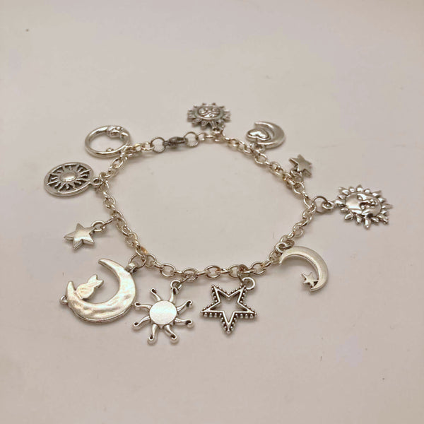 Silver-tone celestial charm bracelet with crescent moon, sun, star and hexagram charms on a link chain