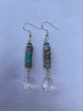 Pair of beaded earrings on a light blue background