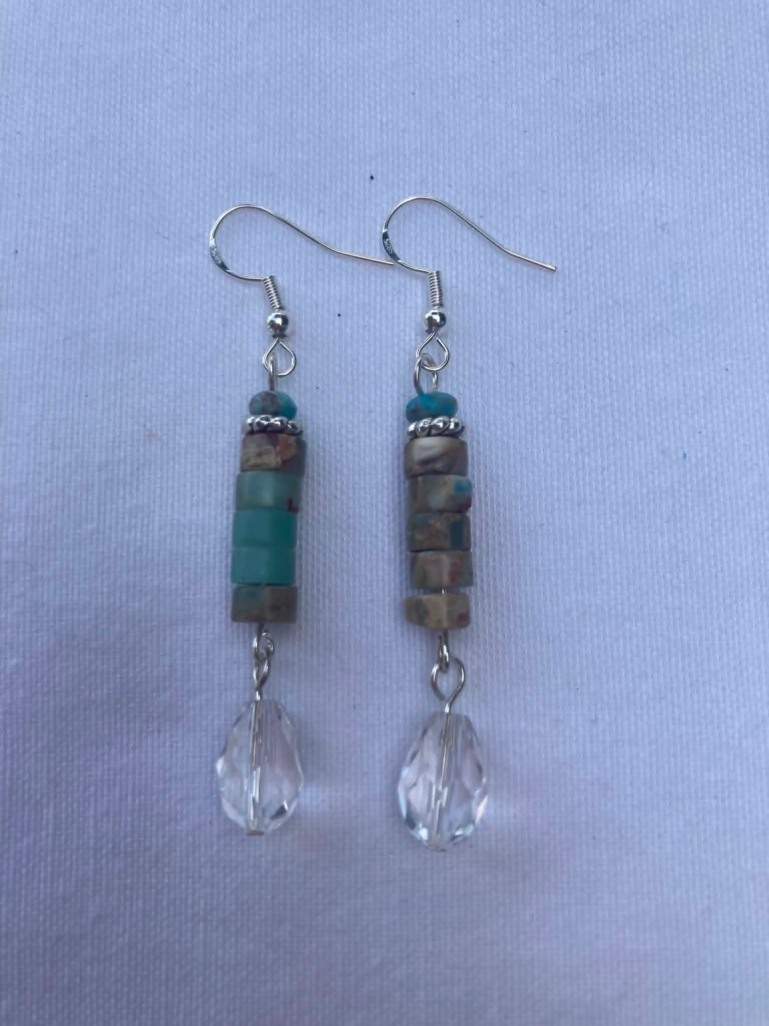 Pair of beaded earrings on a light blue background