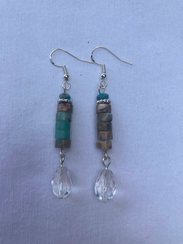 Pair of beaded earrings on a light blue background