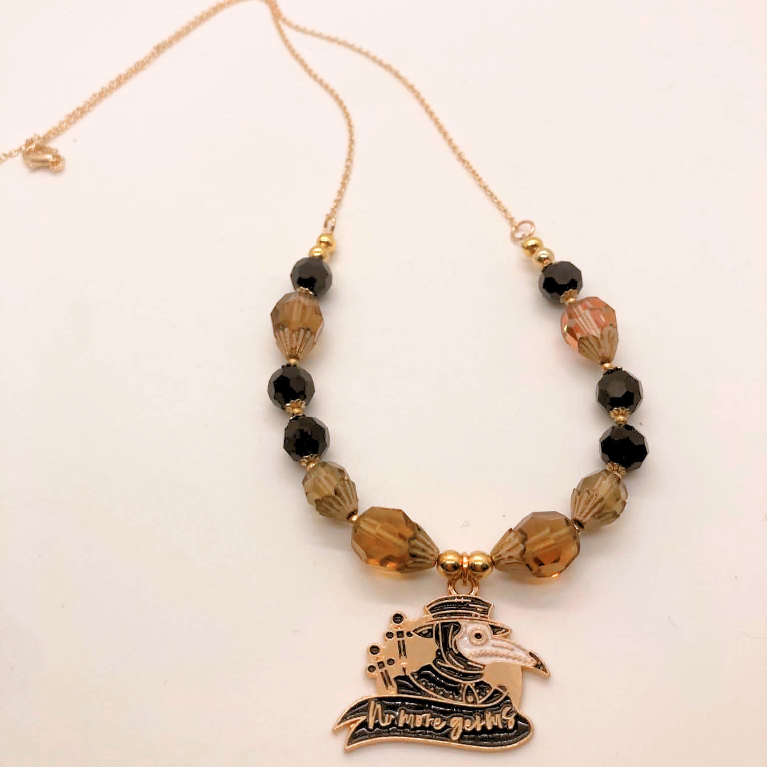 No More Germs plague doctor pendant necklace with black and smoky crystal beads on gold chain