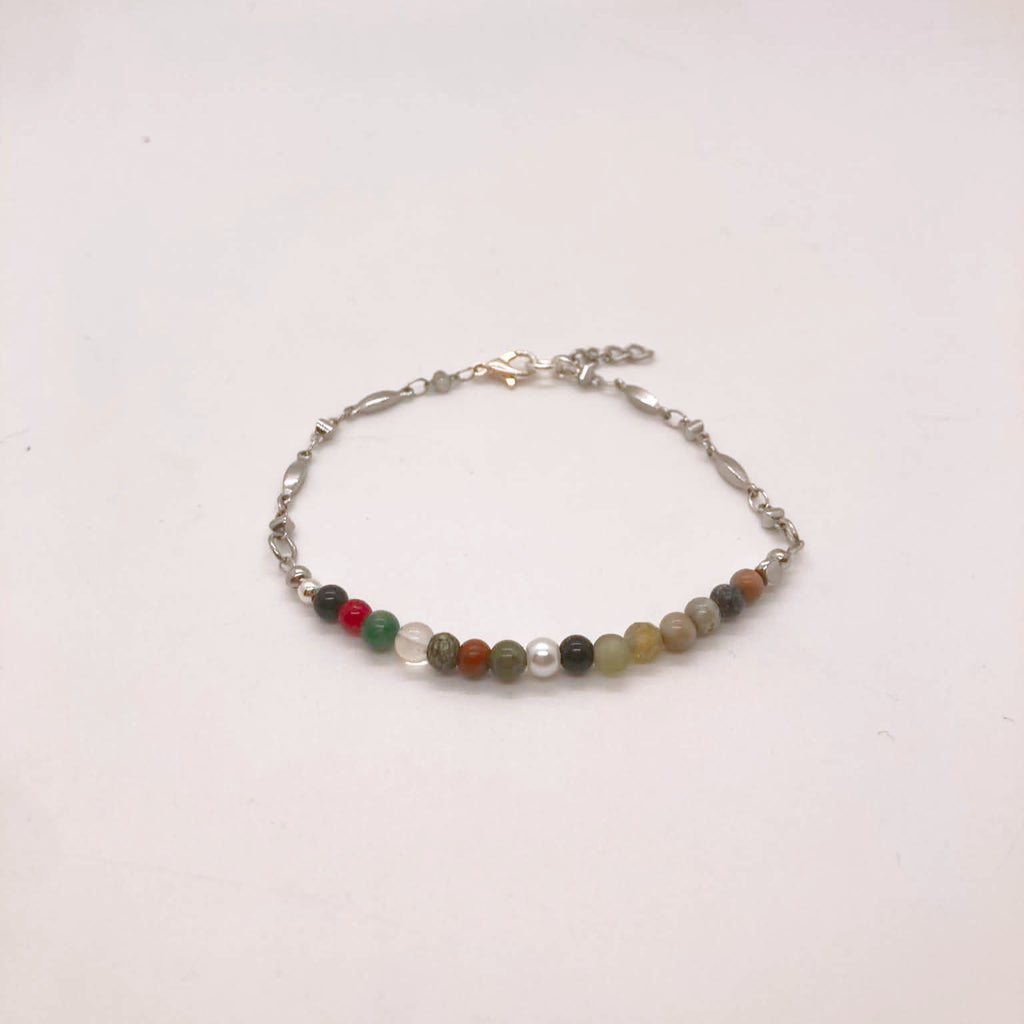Dainty mixed gemstone bracelet with clear quartz, Picasso jasper, mookaite, moonstone and Venus jasper beads on silver figaro chain