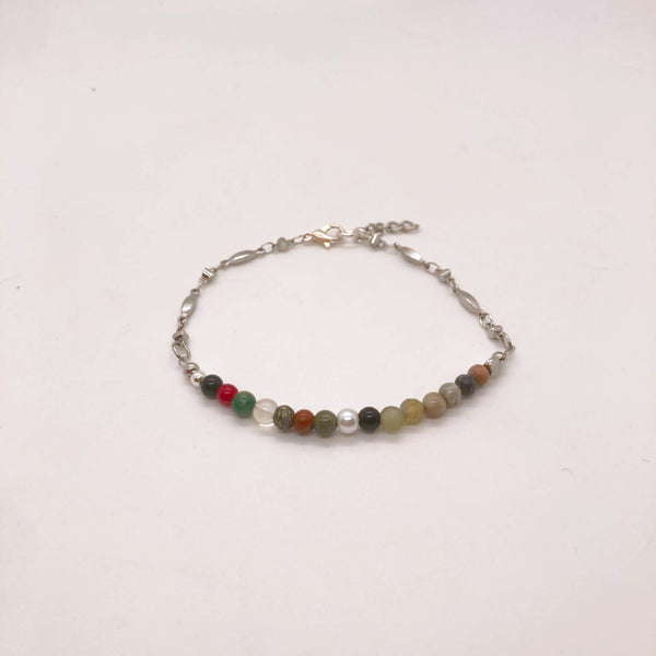 Dainty mixed gemstone bracelet with clear quartz, Picasso jasper, mookaite, moonstone and Venus jasper beads on silver figaro chain