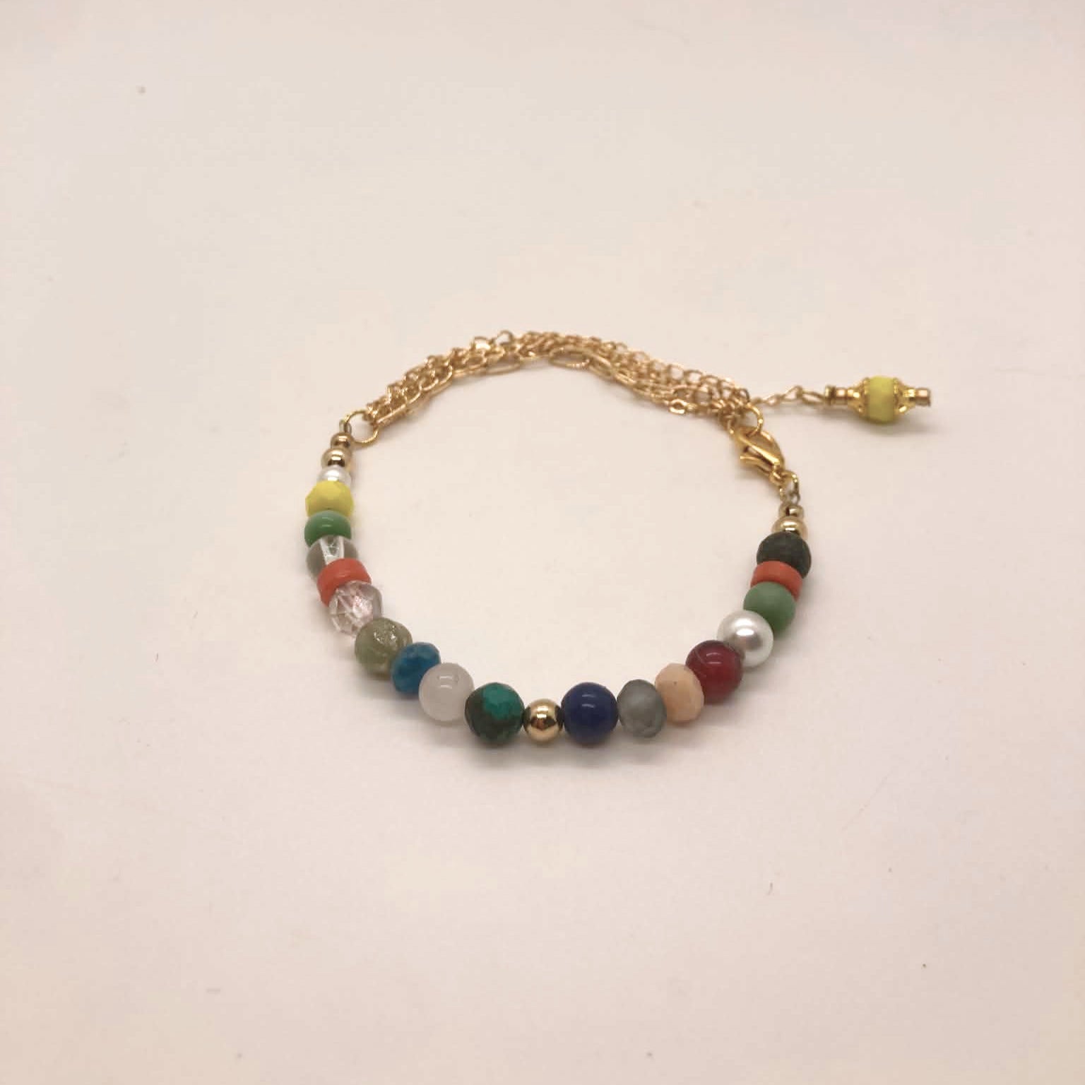 Colorful mixed gemstone bracelet with malachite, lapis lazuli, coral, African turquoise, jet, glass pearls and gold accent beads