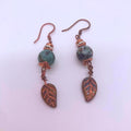 African turquoise and copper Czech glass leaf dangle earrings on white background